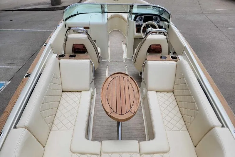 Slide: The Image of 2024 Chris-Craft Launch 27 interior with luxurious seating and wooden table. - 7