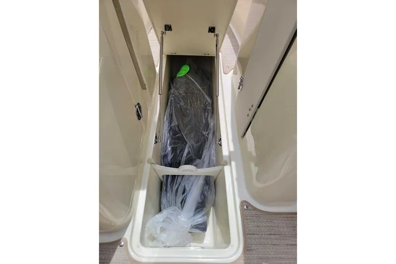 Slide: The Image of 2024 Chris-Craft Launch 27 storage compartment with protective cover inside. - 9