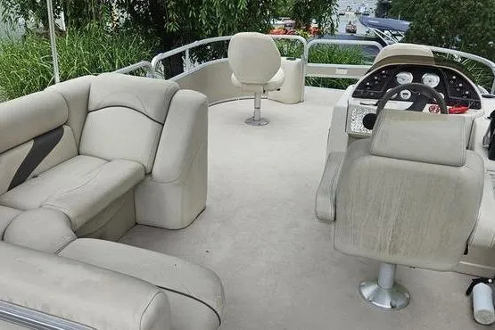Slide: The Image of 2014 SunChaser Classic Fish 8522 4-PT pontoon boat interior with beige seating and steering console. - 16