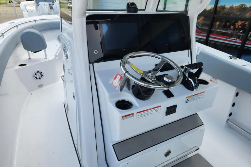 Slide: The Image of 2026 Sportsman Open 252 Center Console boat dashboard with steering wheel and controls. - 10