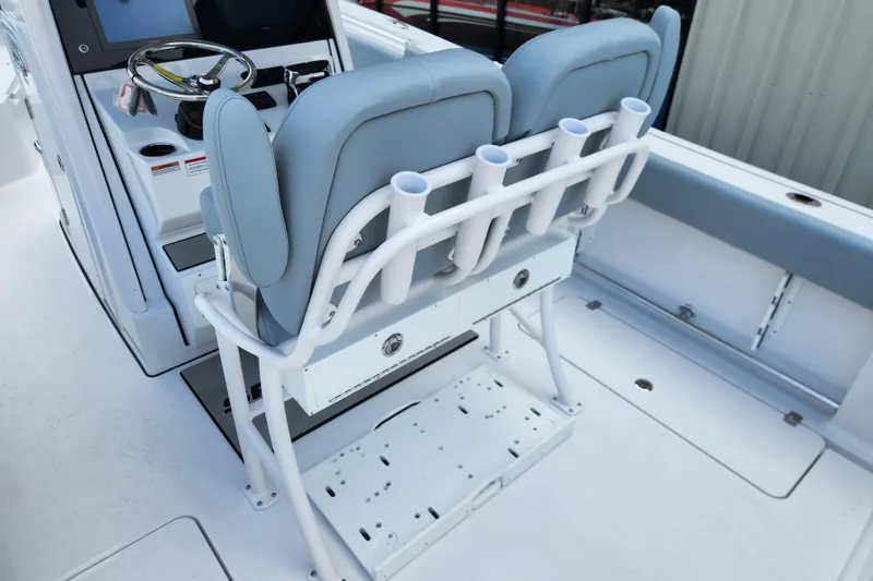 Slide: The Image of 2026 Sportsman Open 252 Center Console boat interior with dual seats and rod holders. - 12