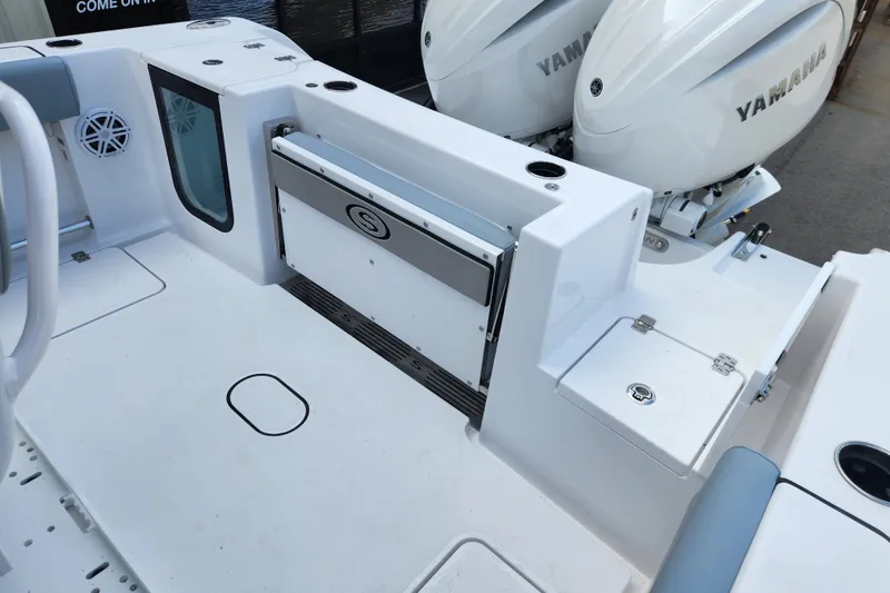 Slide: The Image of 2026 Sportsman Open 252 Center Console boat deck with Yamaha engines, featuring storage and seating. - 13