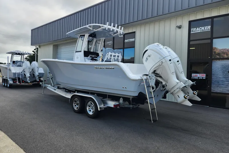 Slide: The Image of 2026 Sportsman Open 252 Center Console boat on trailer outside dealership. - 2