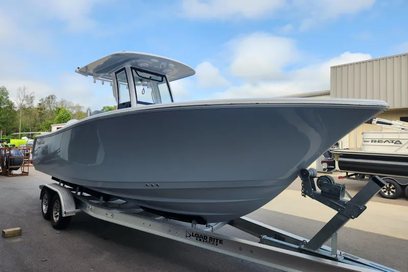Slide: The Image of 2026 Sportsman Open 252 Center Console boat on trailer, parked outdoors. - 5