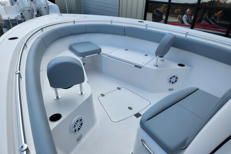 Slide: The Image of 2026 Sportsman Open 252 Center Console boat interior with cushioned seating and storage compartments. - 6