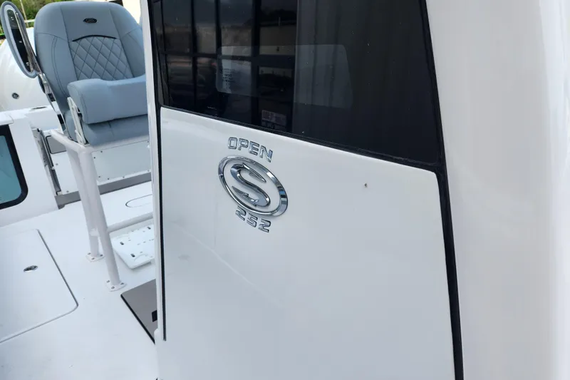 Slide: The Image of 2026 Sportsman Open 252 Center Console boat interior with seating and logo. - 9