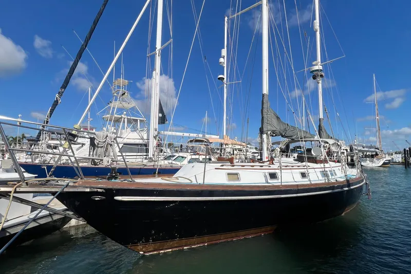 The Image of 1977 Gulfstar 50 sailboat docked at marina under clear blue sky. - 1