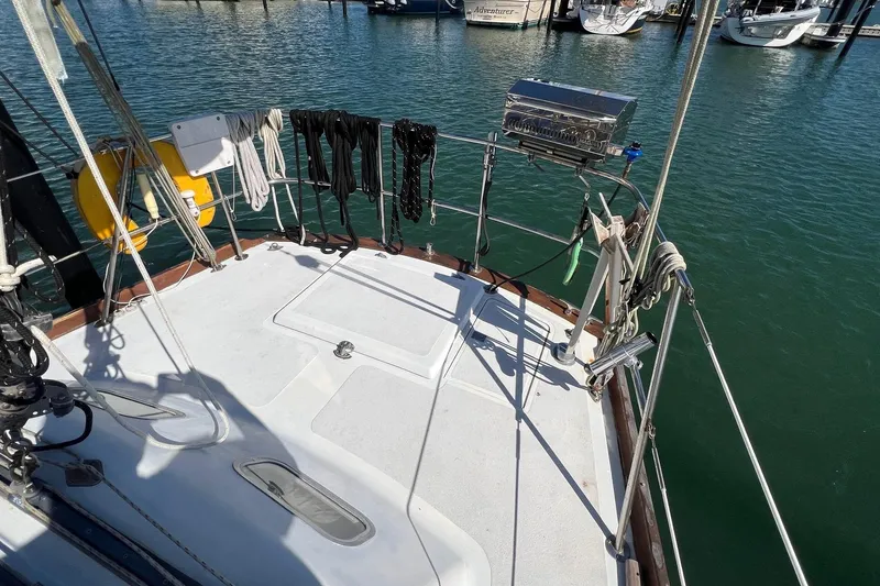 Slide: The Image of 1977 Gulfstar 50 sailboat deck with ropes and equipment in a marina setting. - 10