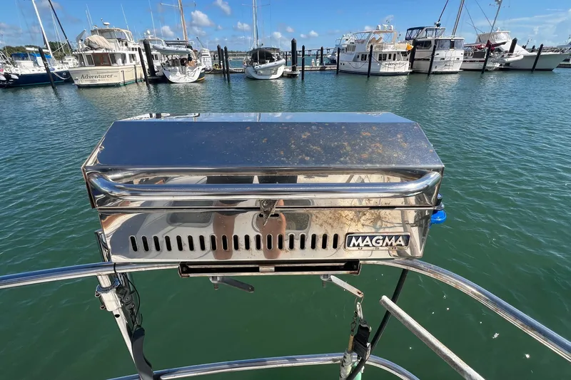 Slide: The Image of Stainless steel Magma grill on a 1977 Gulfstar 50 yacht, docked at a marina. - 13