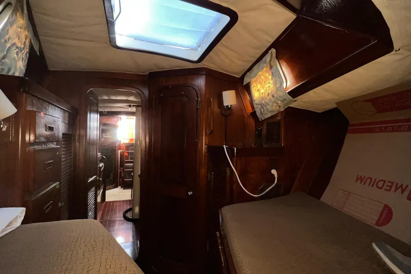 Slide: The Image of Interior of a 1977 Gulfstar 50 sailboat with wooden cabinetry and skylight. - 17