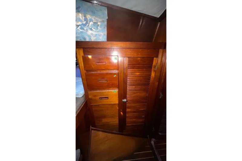 Slide: The Image of 1977 Gulfstar 50 interior with wooden drawers and louvered cabinet door. - 18