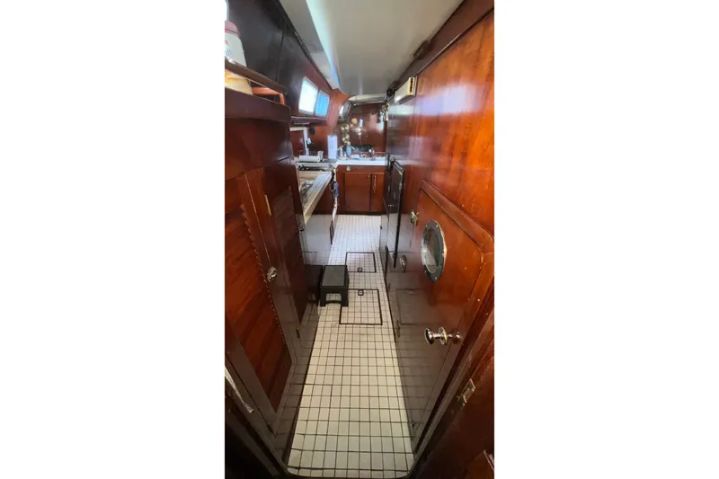 Slide: The Image of 1977 Gulfstar 50 yacht interior with wooden cabinetry and tiled flooring. - 20