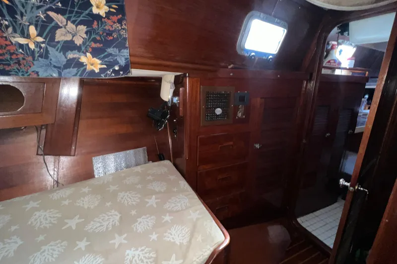 Slide: The Image of 1977 Gulfstar 50 yacht interior with wooden cabinetry and floral decor. - 21