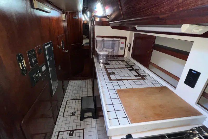 Slide: The Image of 1977 Gulfstar 50 yacht interior with wooden cabinetry and tiled countertops. - 28