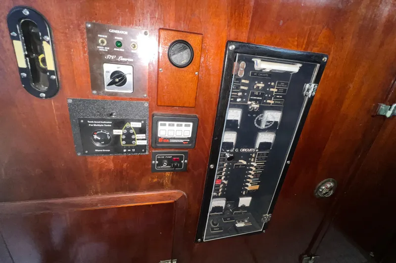 Slide: The Image of Control panel of a 1977 Gulfstar 50 yacht with various switches and gauges. - 29