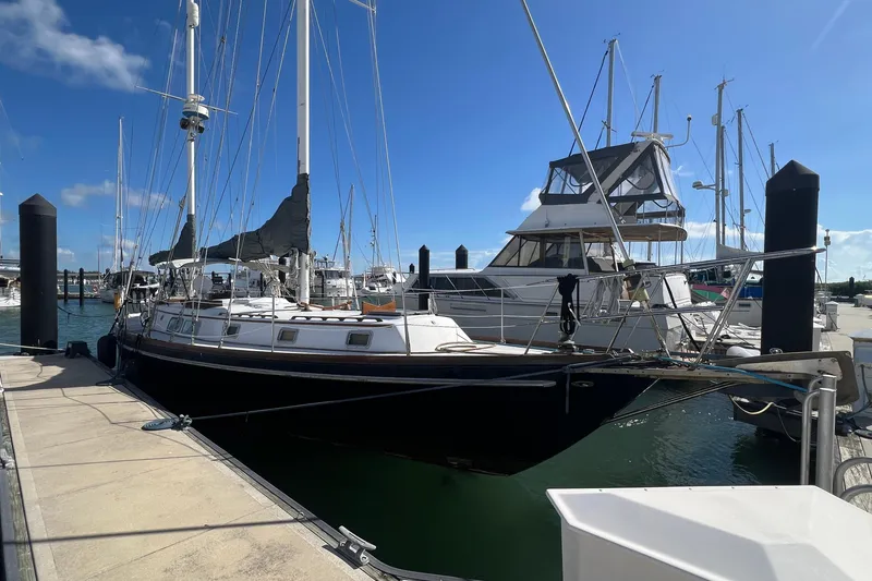 Slide: The Image of 1977 Gulfstar 50 sailboat docked at marina under clear blue sky. - 3