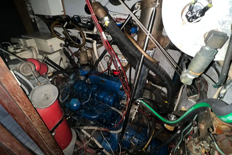 Slide: The Image of Engine room of a 1977 Gulfstar 50 sailboat with visible machinery and wiring. - 30