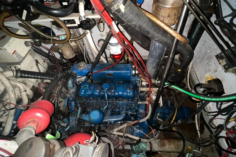 Slide: The Image of Engine room of a 1977 Gulfstar 50 sailboat, featuring complex wiring and machinery. - 31