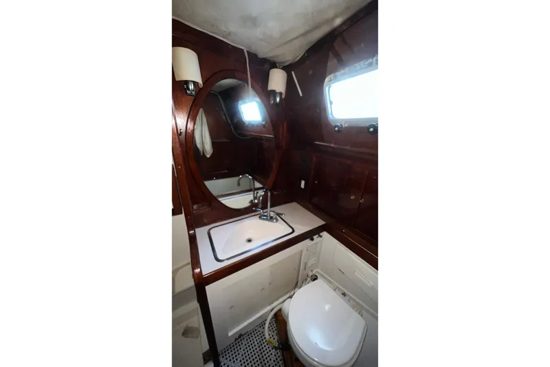 Slide: The Image of Bathroom interior of 1977 Gulfstar 50 yacht with wooden accents and porthole window. - 34