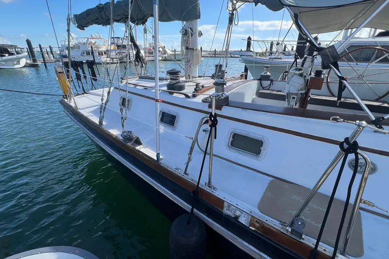 Slide: The Image of 1977 Gulfstar 50 sailboat docked at marina, featuring sleek design and rigging. - 5