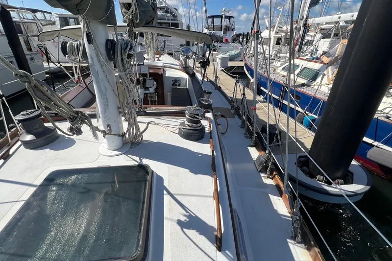 Slide: The Image of 1977 Gulfstar 50 sailboat docked, showcasing deck and rigging details. - 7