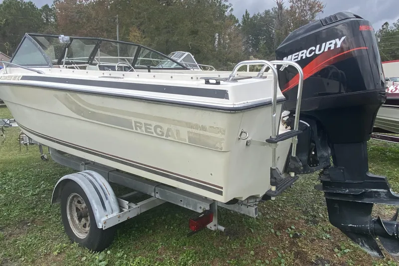 Slide: The Image of 1979 Regal 1800 Bowrider boat with Mercury outboard motor on trailer. - 3