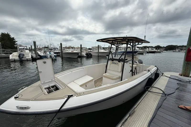 The Image of 2023 LFG 22 boat docked at marina under cloudy sky. - 1
