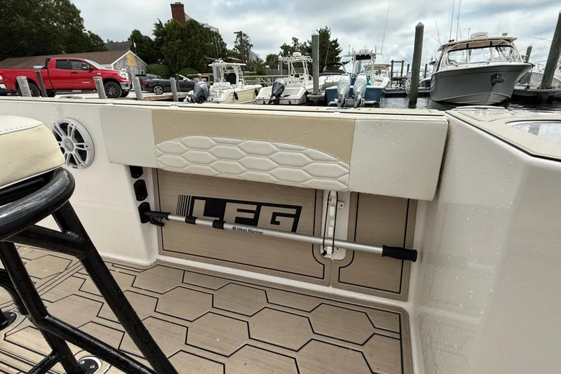 Slide: The Image of Boat interior featuring LFG 22 model, 2023, with hexagonal pattern flooring and docked vessels. - 3