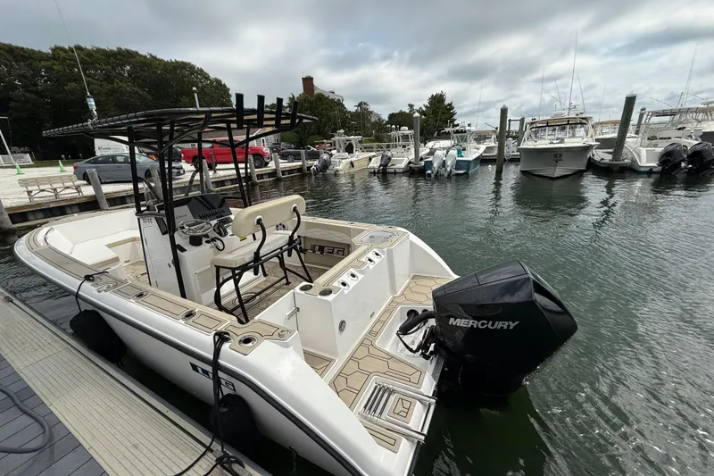 Slide: The Image of LFG 22 boat docked at marina, featuring Mercury engine, 2023 model. - 7
