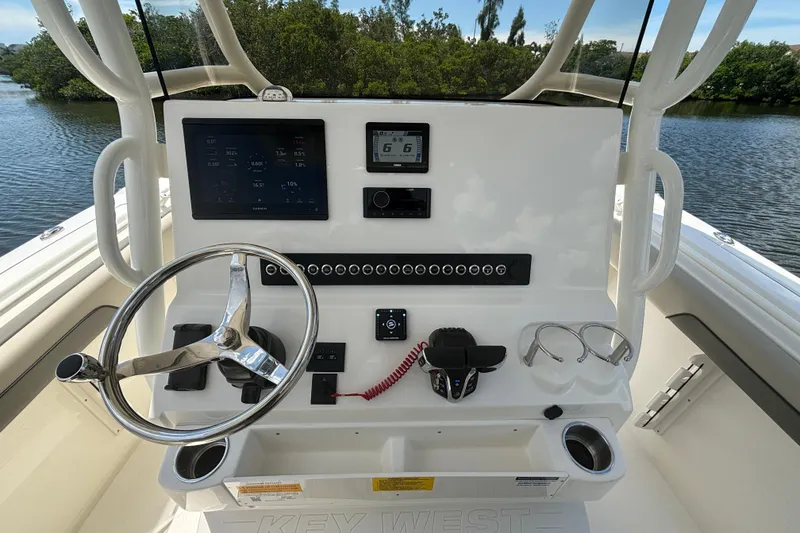Slide: The Image of 2026 Key West 260 CC boat dashboard with steering wheel and electronic controls. - 11