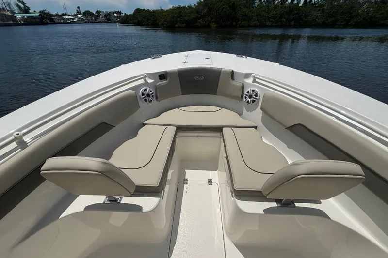 Slide: The Image of 2026 Key West 260 CC boat interior with beige seating, on a calm waterway. - 12