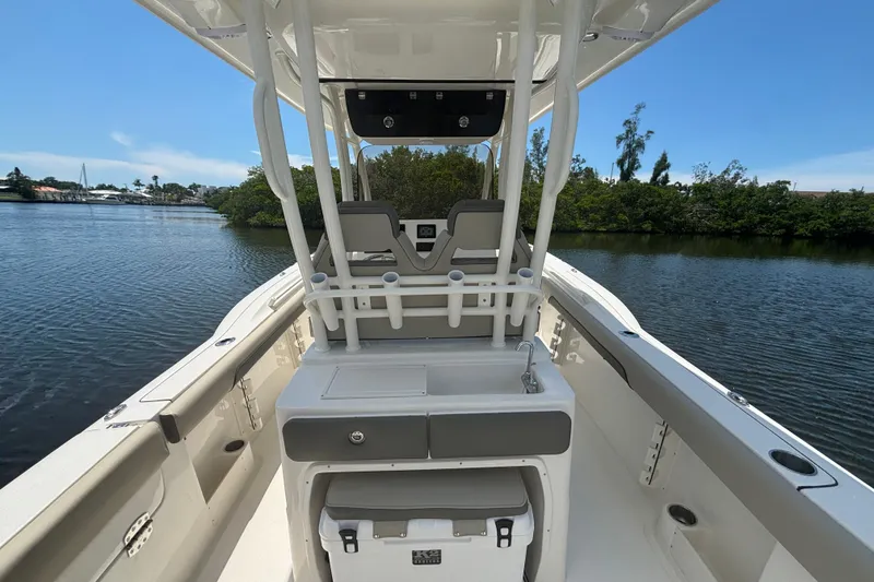 Slide: The Image of 2026 Key West 260 CC boat interior on calm water, featuring seating and storage. - 8
