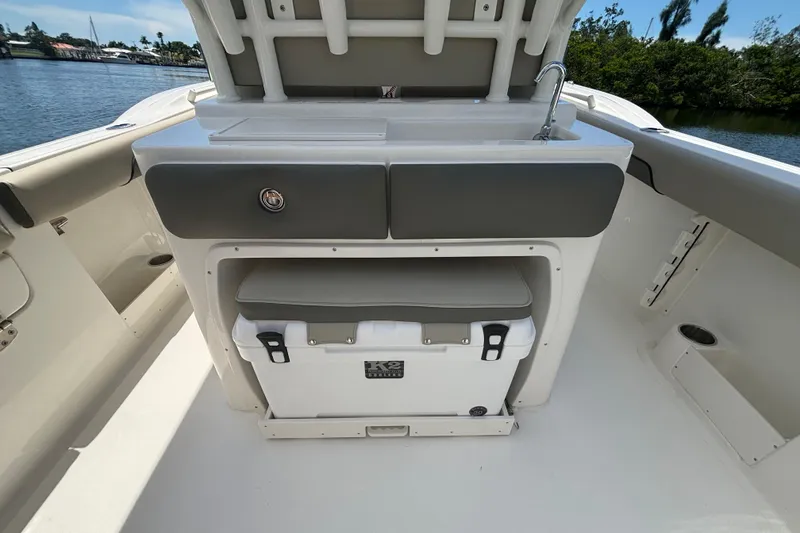 Slide: The Image of 2026 Key West 260 CC boat interior with storage and cooler on deck. - 9