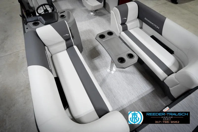 Slide: The Image of 2026 Bennington 20 SSR pontoon boat interior with gray and white seating and cup holders. - 11
