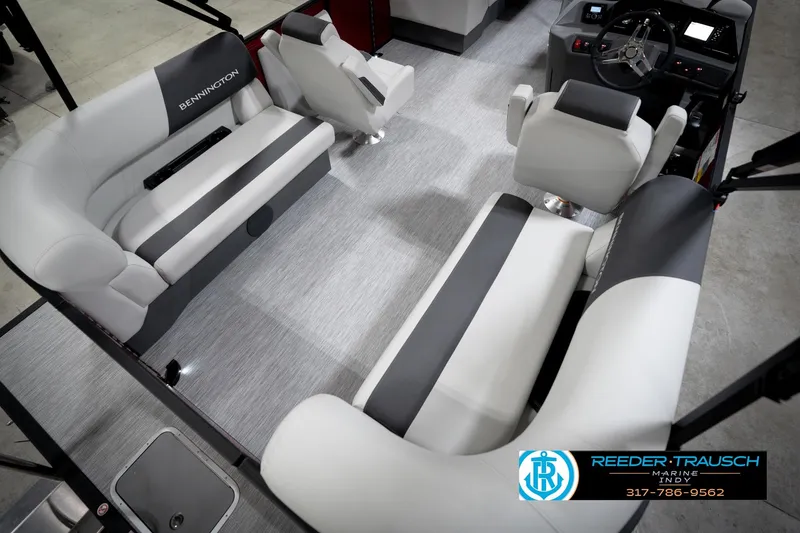 Slide: The Image of 2026 Bennington 20 SSR boat interior with gray and white seating, cup holders, and steering console. - 12