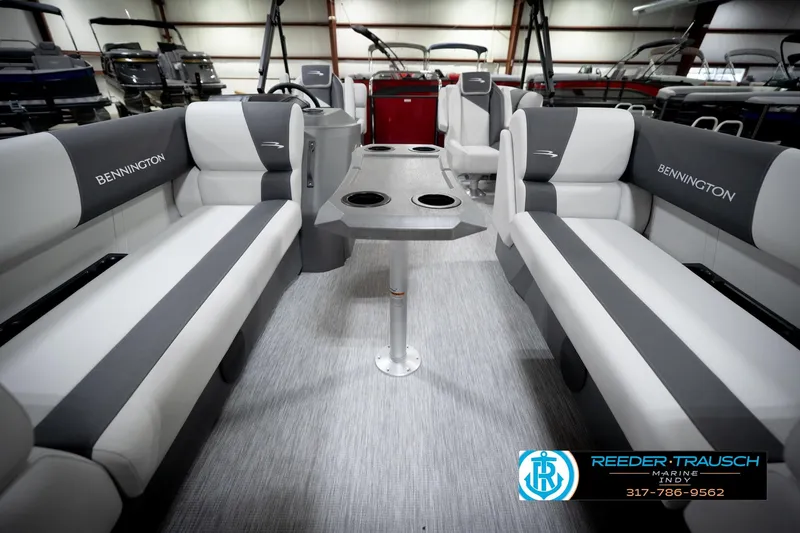 Slide: The Image of 2026 Bennington 20 SSR boat interior with gray and white seating, cup holders, and logo. - 14