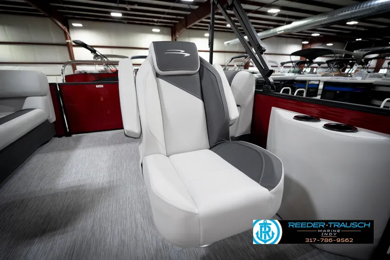 Slide: The Image of 2026 Bennington 20 SSR pontoon boat interior with open storage compartment, showcasing seating and flooring. - 24