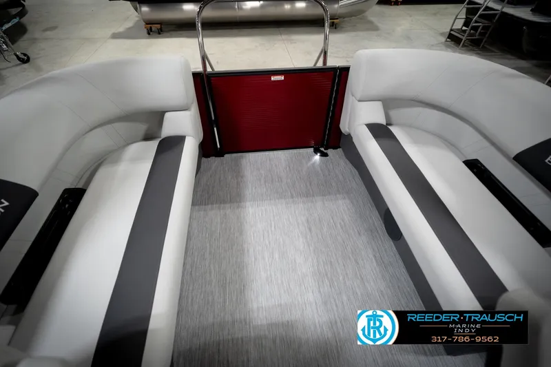 Slide: The Image of 2026 Bennington 20 SSR boat interior with plush seating in a showroom. - 26