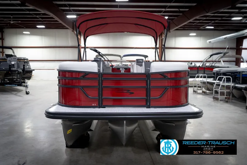 Slide: The Image of 2026 Bennington 20 SSR pontoon boat with red canopy in showroom. - 3