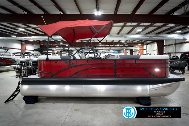 Slide: The Image of 2026 Bennington 20 SSR pontoon boat with red canopy in showroom. - 5