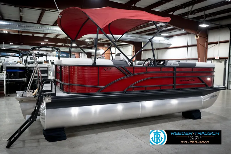 Slide: The Image of 2026 Bennington 20 SSR pontoon boat with red canopy in showroom. - 6