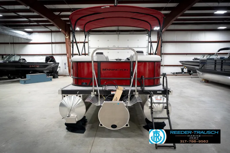 Slide: The Image of 2026 Bennington 20 SSR pontoon boat with red canopy in showroom. - 7