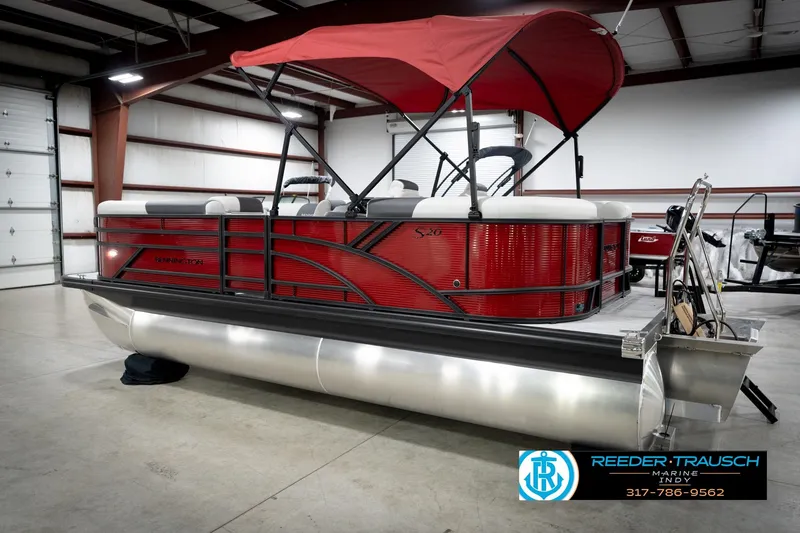 Slide: The Image of 2026 Bennington 20 SSR pontoon boat with red canopy in a showroom. - 8