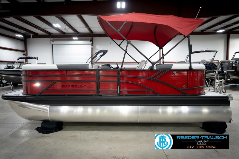 Slide: The Image of 2026 Bennington 20 SSR pontoon boat with red canopy in showroom. - 9