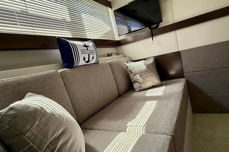 Slide: The Image of Interior of 2020 Cruisers Yachts 42 Cantius with cozy seating and nautical decor. - 12