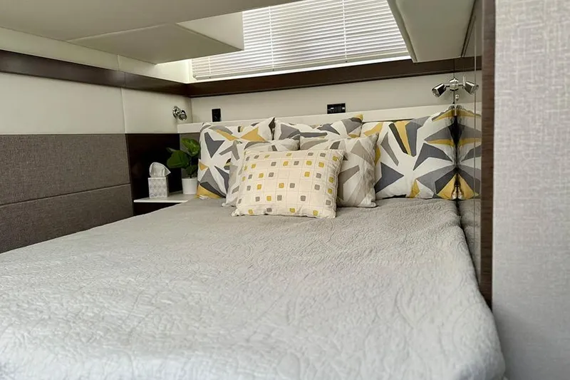 Slide: The Image of Luxurious bedroom interior of 2020 Cruisers Yachts 42 Cantius with modern decor and cozy bedding. - 11