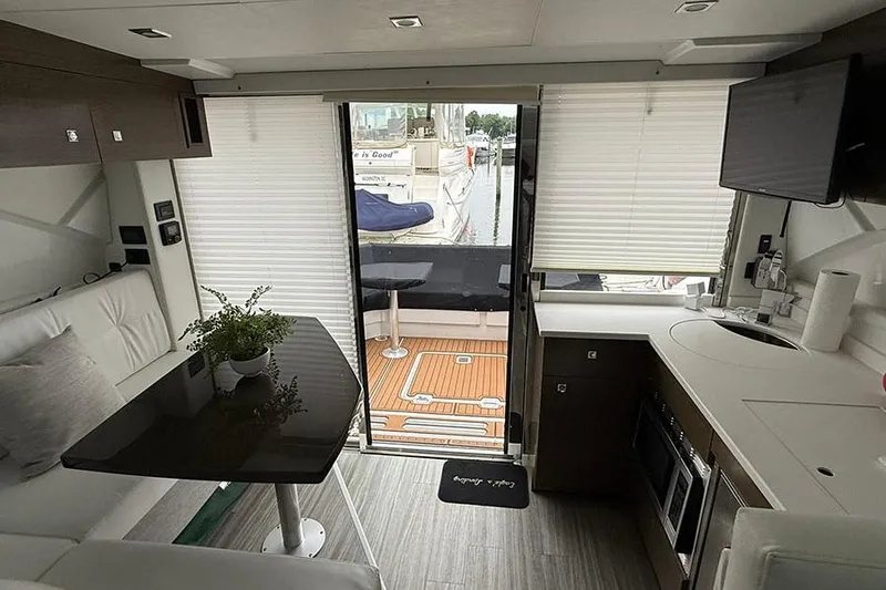 Slide: The Image of Interior of 2020 Cruisers Yachts 42 Cantius with modern kitchen and seating area. - 8