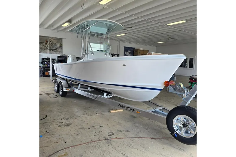 Slide: The Image of 2026 Albury Brothers 23 boat on trailer in indoor storage facility. - 0