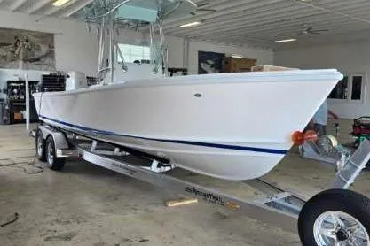 Slide: The Image of 2026 Albury Brothers 23 boat on trailer in indoor storage facility. - 1