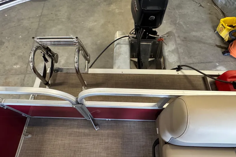 Slide: The Image of 2023 Sun Tracker Bass Buggy 16 XL Select pontoon boat interior with motor and seating. - 13